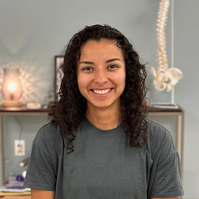 Alejandra Suarez smiling. She has dark curly hair.